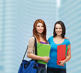 Image showing two smiling students with bag and folders