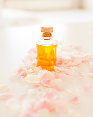 Image showing closeup of essential oil and rose petals