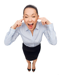 Image showing businesswoman screaming with closed ears