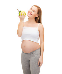 Image showing happy future mother with green apple
