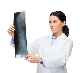 Image showing serious female doctor looking at x-ray