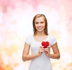 Image showing smiling woman in white t-shirt with heart