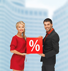 Image showing smiling man and woman with percent sign