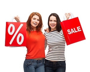 Image showing two smiling teenage girl with shopping bags