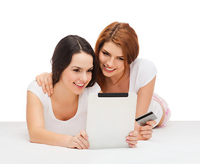 Image showing smiling teenagers with tablet pc and credit card