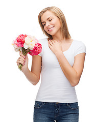 Image showing smiling woman with bouquet of flowers