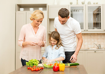 Image showing happy family making dinner in kitchen