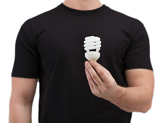 Image showing close up of man holding light bulb