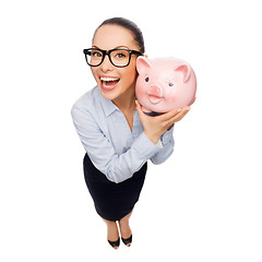 Image showing happy businesswoman in eyeglasses with piggy bank