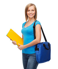 Image showing smiling female student with bag and folders