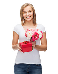 Image showing smiling woman with bouquet of flowers and gift box