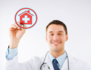 Image showing doctor drawing hospital sign in the air