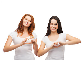 Image showing two smiling girls showing heart with hands