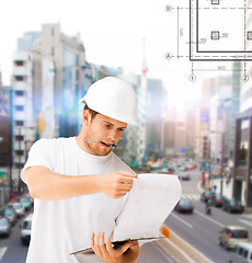 Image showing male architect looking at blueprint