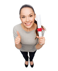 Image showing happy woman with diploma showing thumbs up