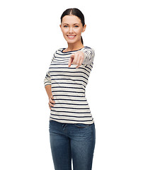 Image showing smiling girl in casual clother pointing at you