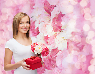 Image showing smiling woman with bouquet of flowers and gift box