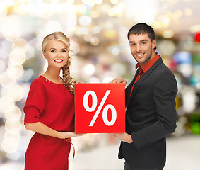 Image showing smiling man and woman with percent sign