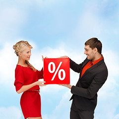 Image showing smiling woman and man with red percent sale sign