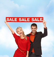 Image showing smiling woman and man with red sale sign