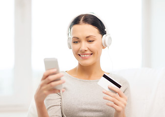 Image showing woman with smartphone and headphones at home