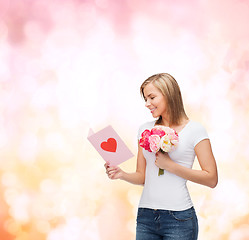 Image showing smiling girl with postcard and bouquet of flowers