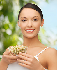 Image showing healthy woman holding bowl with sprout