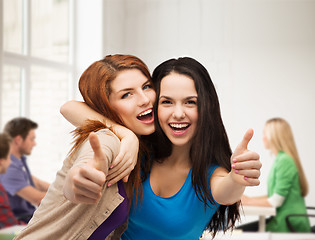 Image showing two smiling girls showing thumbs up