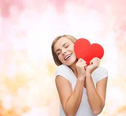 Image showing smiling woman in white t-shirt with heart