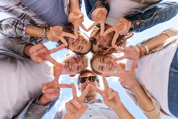 Image showing group of teenagers showing finger five