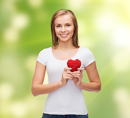 Image showing smiling woman in white t-shirt with heart