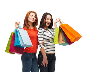 Image showing two smiling teenage girls with shopping bags