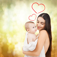 Image showing happy mother feeding her adorable baby