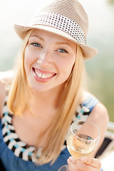 Image showing smiling girl in hat with champagne glass