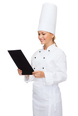 Image showing smiling female chef with black blank paper