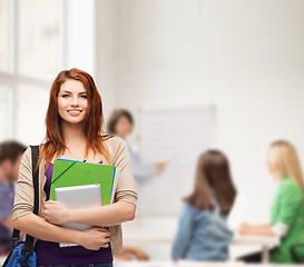 Image showing smiling student with bag, folders and tablet pc