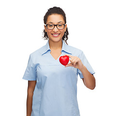 Image showing smiling female doctor or nurse with heart