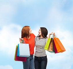 Image showing two smiling teenage girls with shopping bags