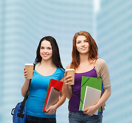 Image showing two students with bag, folders, tablet and coffee