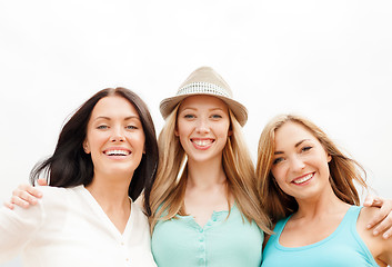 Image showing group of smiling girls chilling on the beach