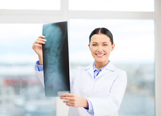 Image showing smiling young doctor in cabinet