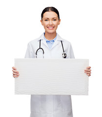 Image showing female doctor with stethoscope and white board