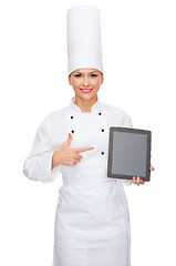 Image showing smiling female chef with tablet pc blank screen