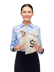 Image showing businesswoman holding money bags with dollar