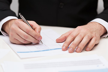 Image showing close up of businessman with papers