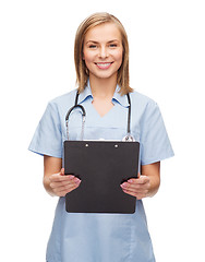 Image showing smiling female doctor or nurse with clipboard