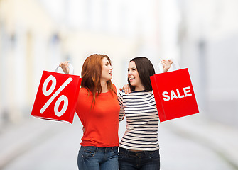 Image showing two smiling teenage girl with shopping bags