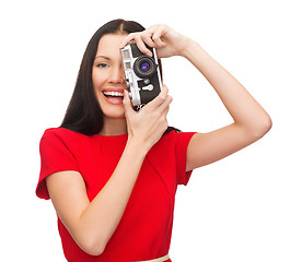 Image showing smiling woman taking picture with digital camera