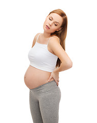 Image showing tired future mother supporting her back