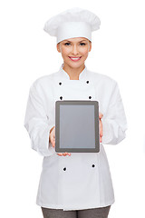 Image showing smiling female chef with tablet pc blank screen